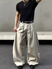 Men's wide leg pants in apricot with pleats and a chain detail belt.