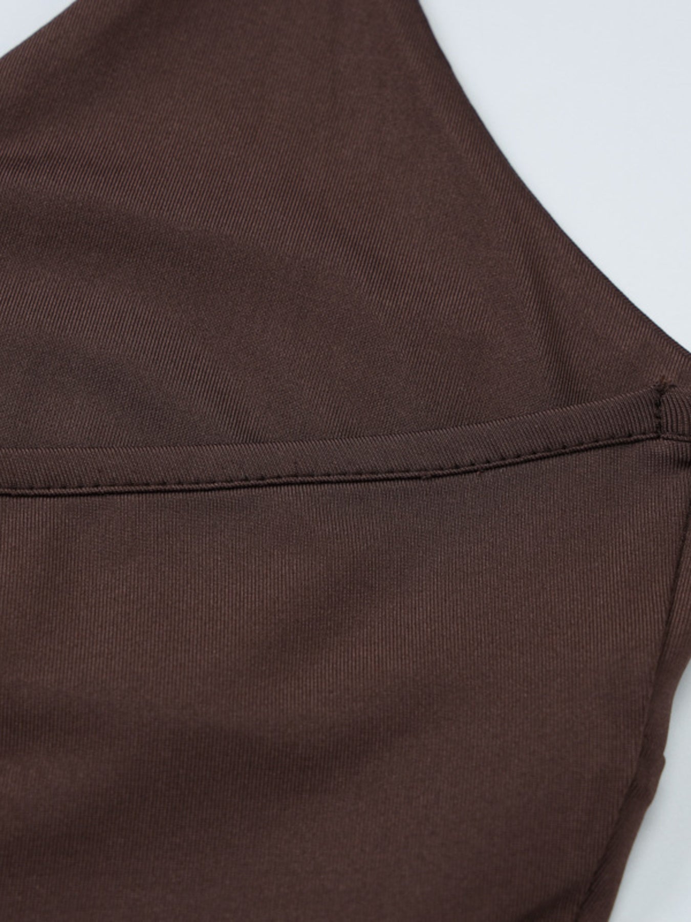 Coffee brown halter neck cami with twist detail and visible stitching.