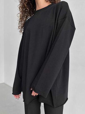 Black oversized cotton jersey top with long sleeves and a crew neck.