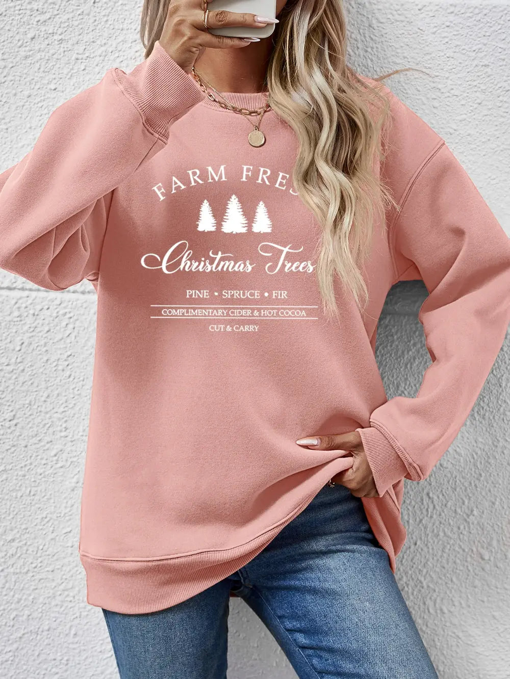 Blush pink graphic sweatshirt with "Farm Fresh Christmas Trees" print, crewneck, long sleeves.