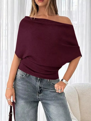 Wine red ruched off-shoulder knit t-shirt with short dolman sleeves.