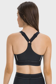 Black performance sports bra with crossback straps and white trim detail.