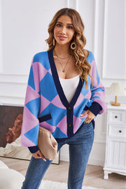 Diamond knit balloon sleeve cardigan in blue and pink with navy trim and pockets.