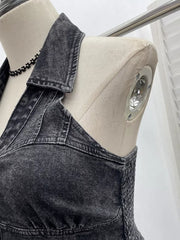 Gathered denim halter top with collar in black, featuring smocked sides and a button-down front detail.