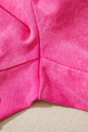 Acid-washed hot pink cotton drawstring shorts with pockets, close-up detail.