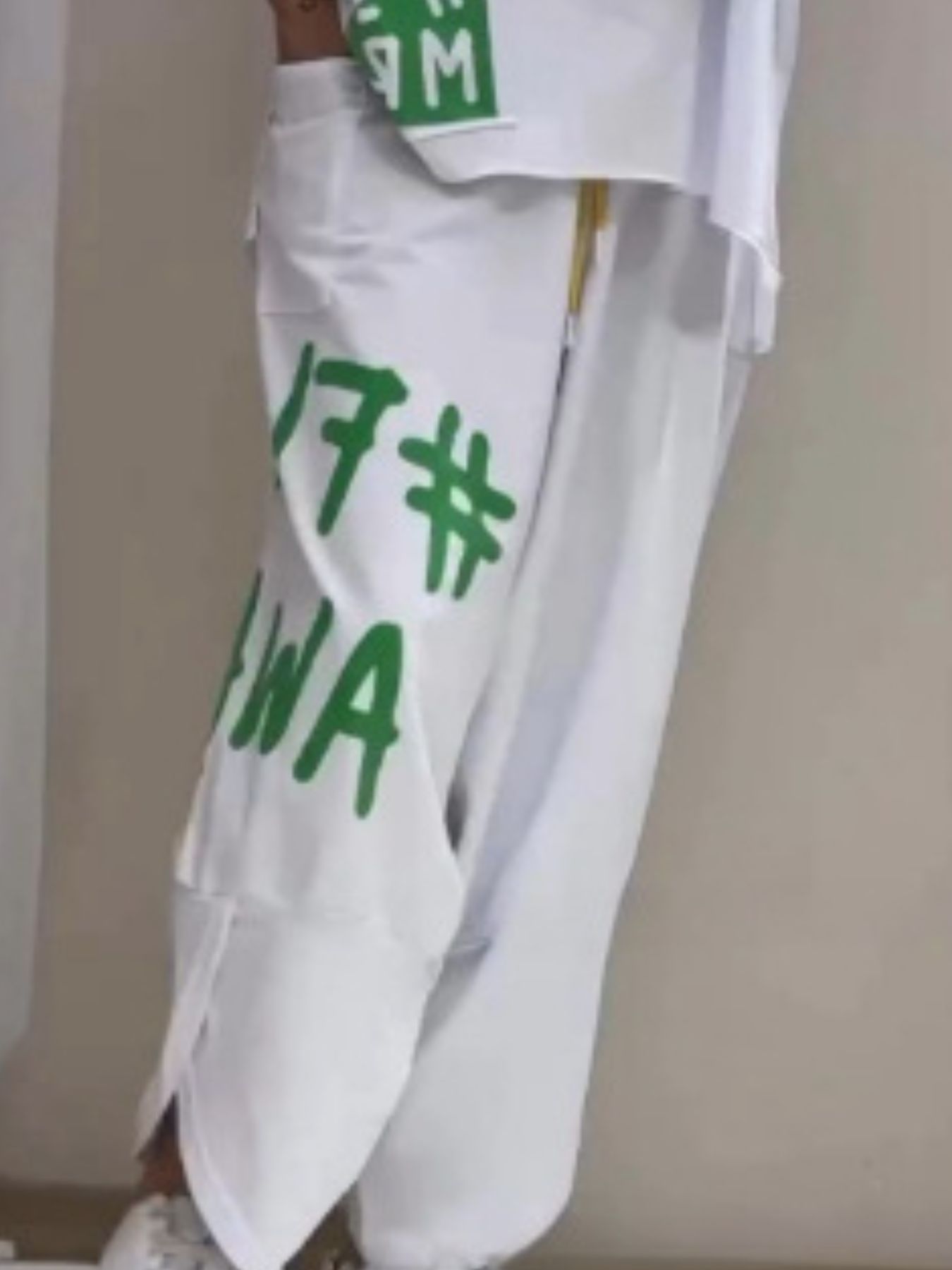 White graphic tee and drawstring pants set with green lettering