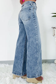 Seamed wide leg denim trousers in medium wash, featuring a high rise and flared hem.