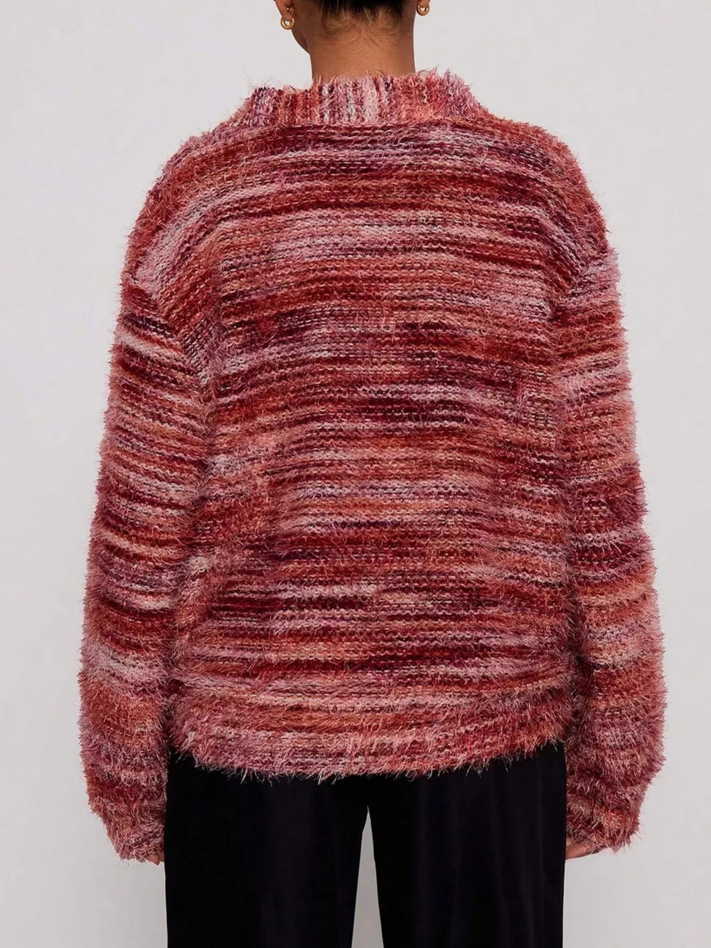 Cozy textured knit cardigan in a marled rust and pink blend with a fuzzy finish and ribbed neckline.