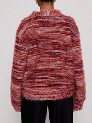 Cozy textured knit cardigan in a marled rust and pink blend with a fuzzy finish and ribbed neckline.