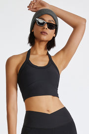 Black ribbed halter crop top with a racerback detail.