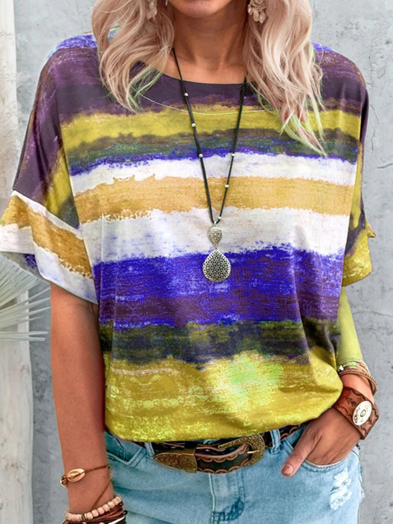 Casual t-shirt with brushstroke stripes in purple, yellow, white, and blue.