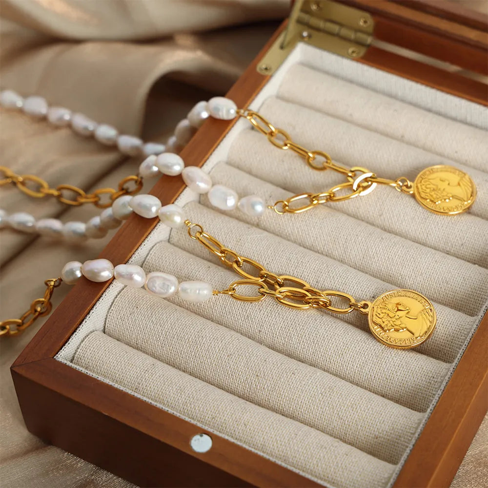 Gold pearl and coin link necklace with baroque pearls and oval chain links.