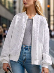 White cable knit bomber jacket with a zip front and ribbed cuffs.
