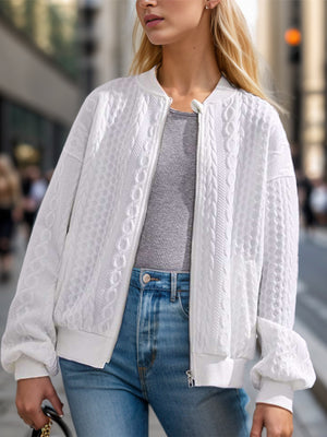 White cable knit bomber jacket with a zip front and ribbed cuffs.