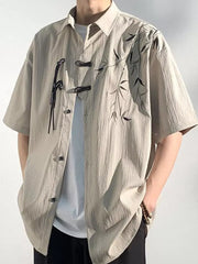 Relaxed fit tan bamboo print short sleeve button-down shirt with frog closures