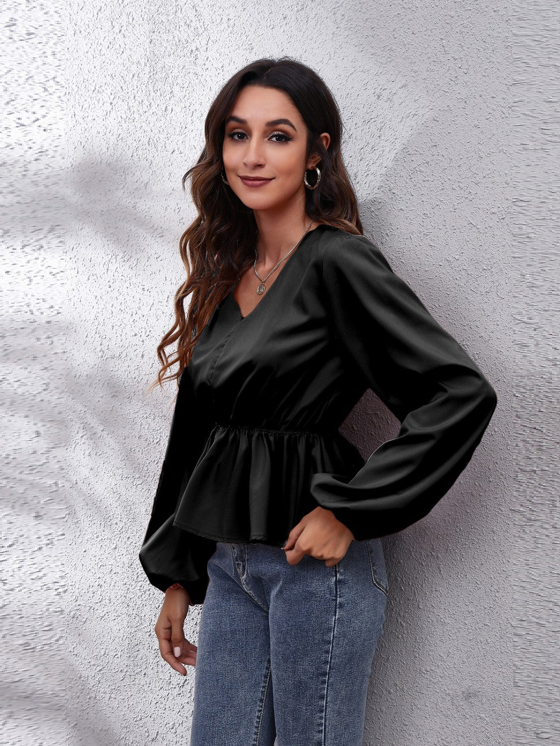 Black peplum blouse with V-neck, gathered waist and balloon sleeves