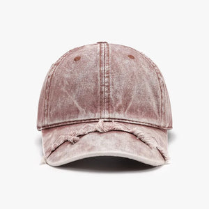 Acid wash distressed baseball cap in dusty pink with frayed brim.