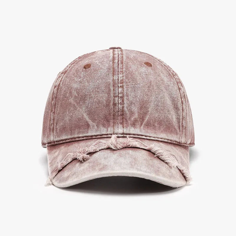 Acid wash distressed baseball cap in dusty pink with frayed brim.