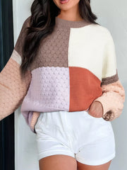 Multicolor ribbed knit sweater with a colorblock pattern and textured details.