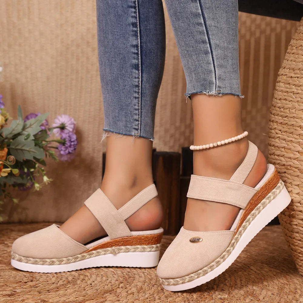 Espadrille wedge slingback sandals in eggshell with crisscross straps and braided jute detail.