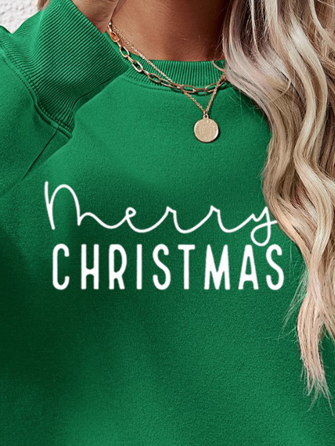 Green Merry Christmas graphic sweatshirt with crew neck and long sleeves.