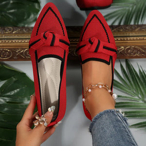 Red mesh pointe slip-on flats with black trim and bow detail.