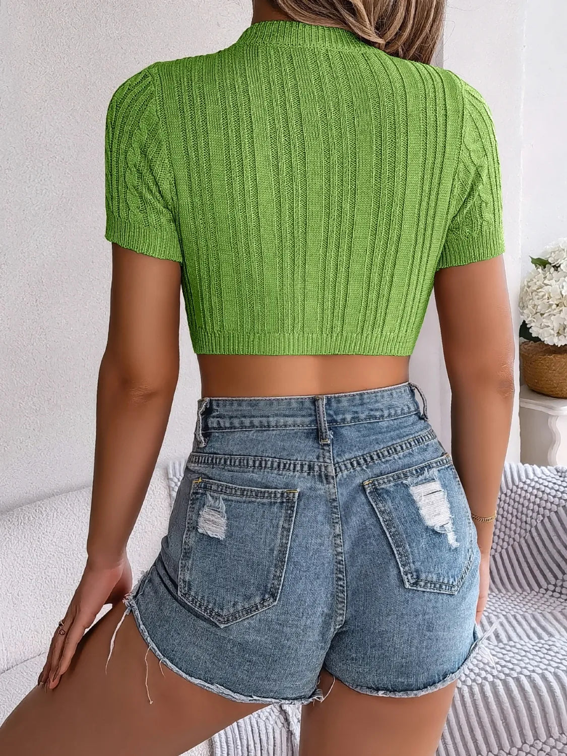 Green cable knit crop top with openwork detail and short sleeves, made of 100% viscose.