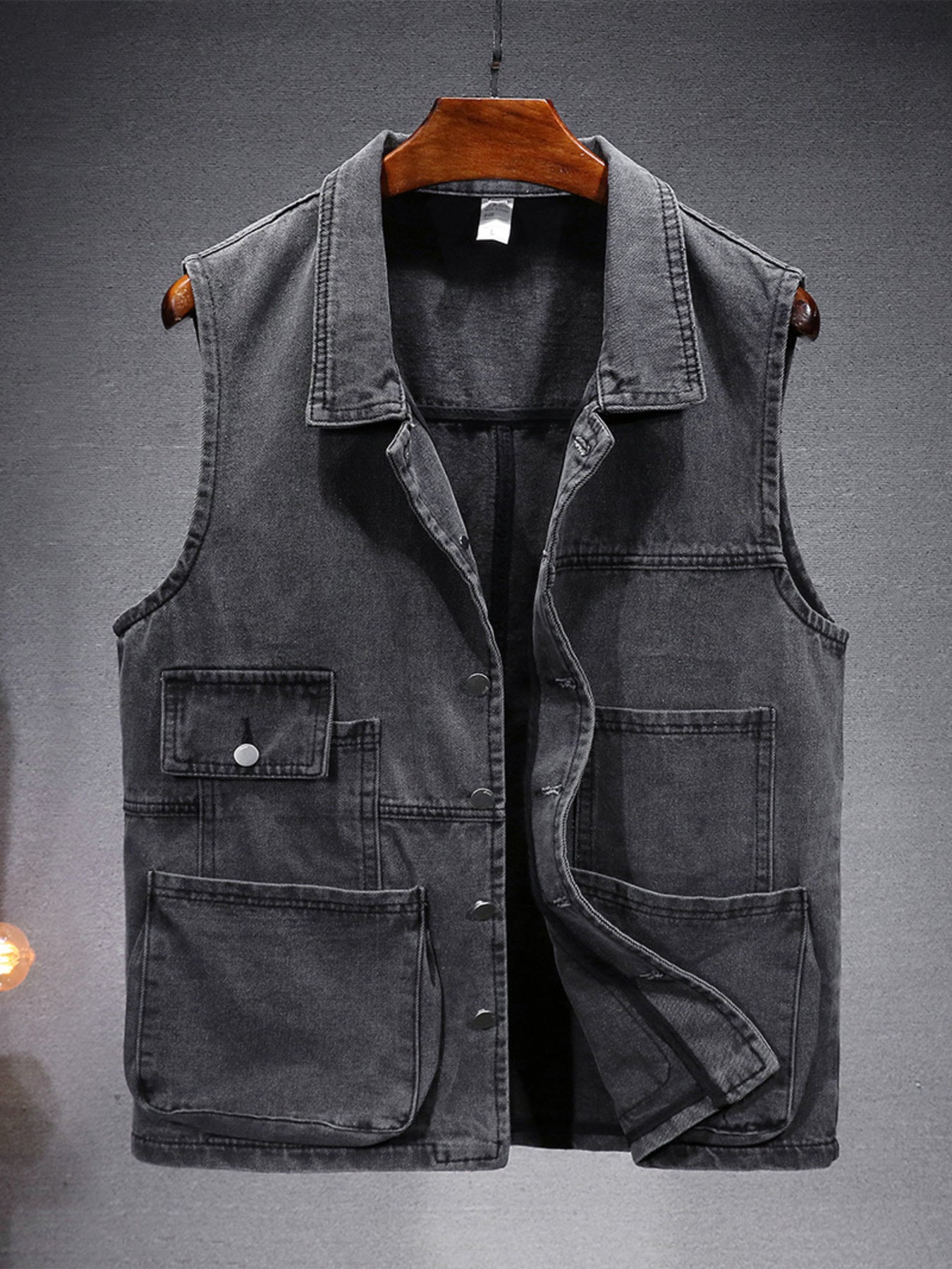 Men's gray denim vest with multiple pockets and button closure.