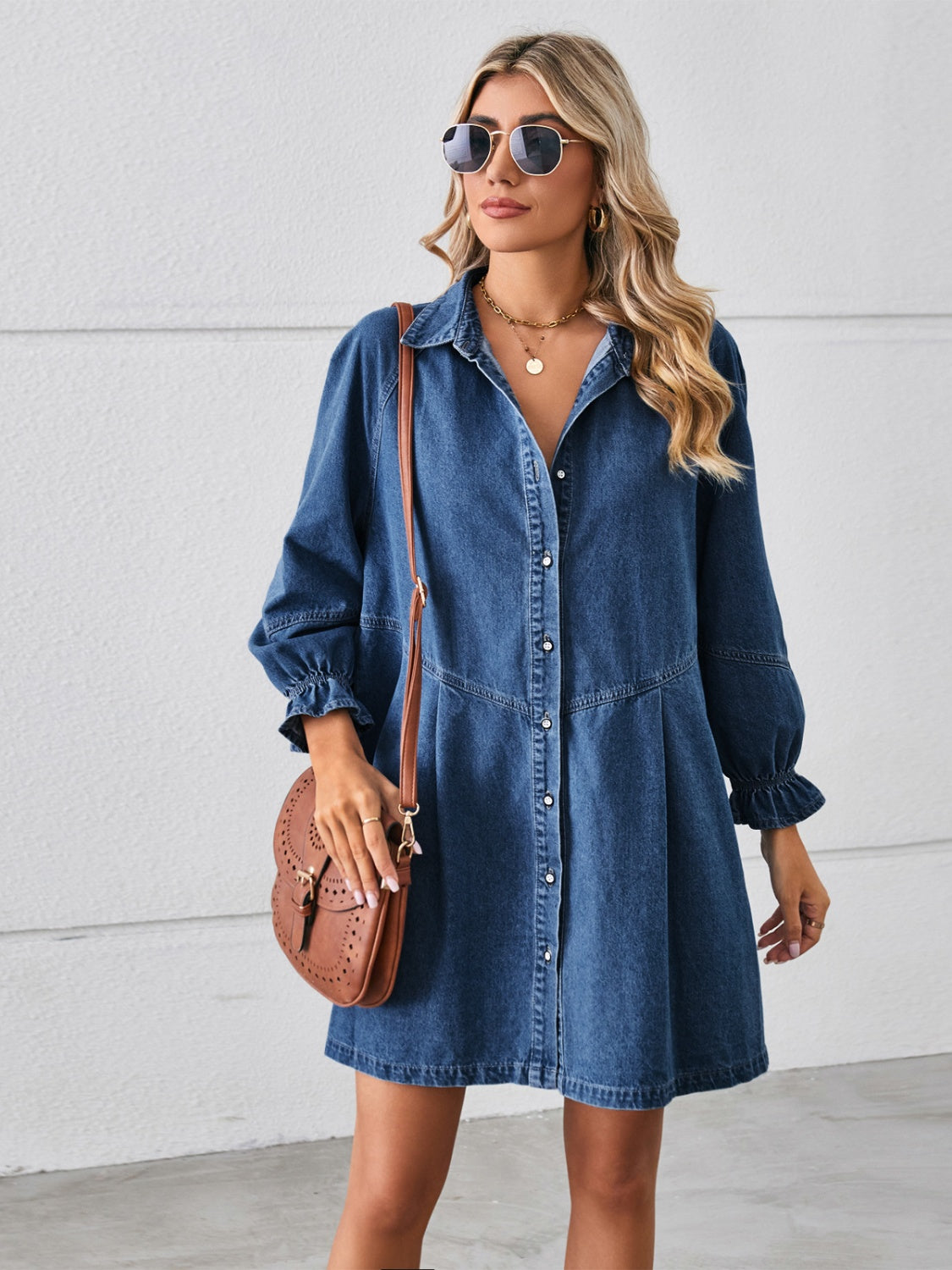 Denim shirtdress in dark blue with ruffled cuff sleeves and button front.