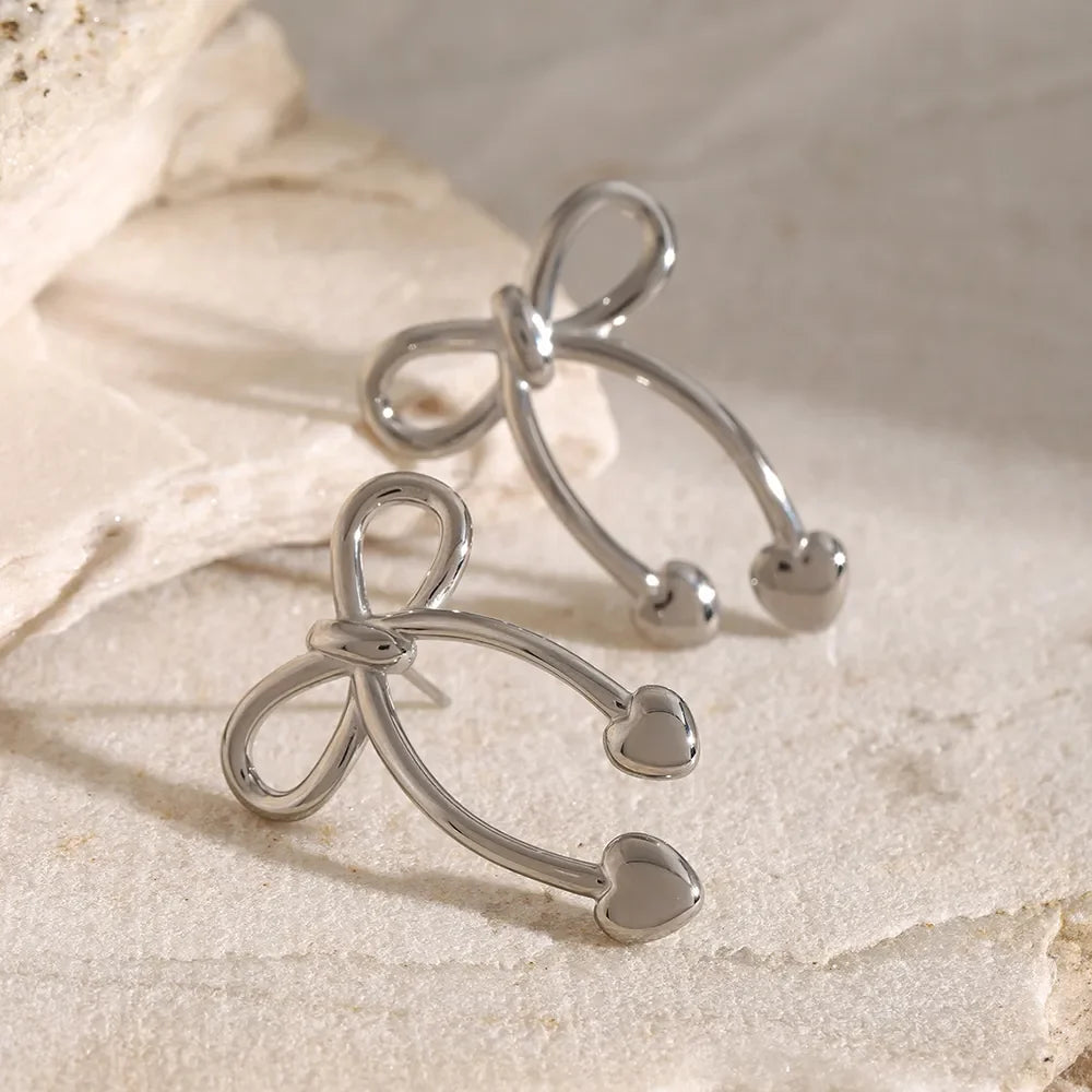 Silver bow drop earrings with heart tips