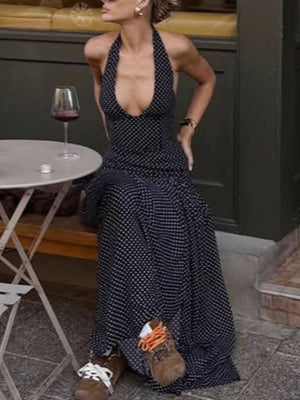 Black polka dot halter neck maxi dress with a plunging neckline and backless detail.