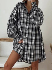 Black and white plaid shirt with button front and ribbed cuffs.
