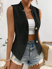 Black button-down vest with sculpted lapel and gold buttons, styled with a white crop top and denim shorts.