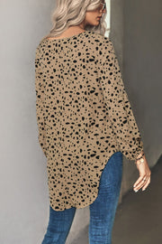 Khaki Dalmatian print blouse with balloon sleeves and a curved hem.