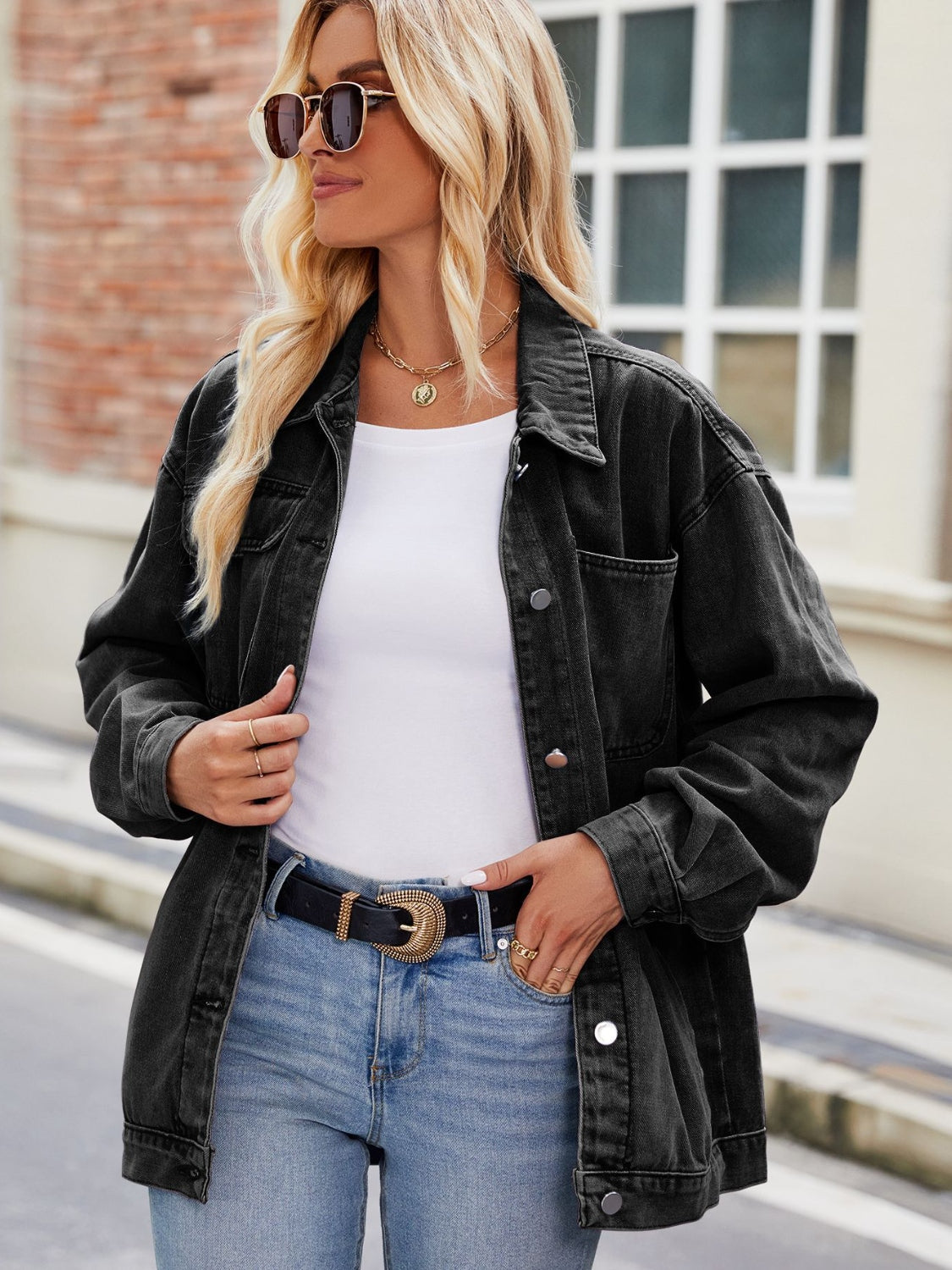 Black oversized denim shacket with button-down front and chest pocket.