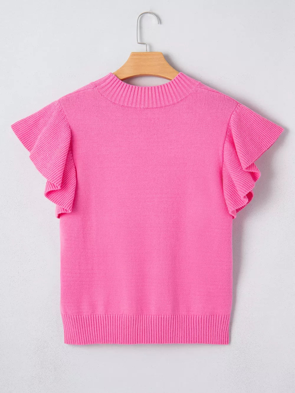 Pink knit top with mock neck and ruffled short sleeves.
