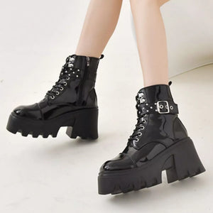 Black patent platform ankle boots with buckle accents and chunky heel