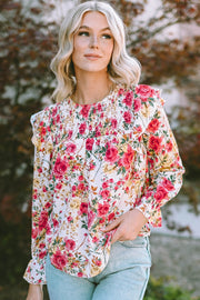 Multicolor floral ruffle smocked yoke blouse with long sleeves.