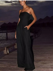 Black strapless wide-leg maternity romper with pockets, full length.