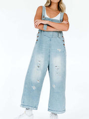 Light blue ripped relaxed fit denim overalls with adjustable straps and button details.