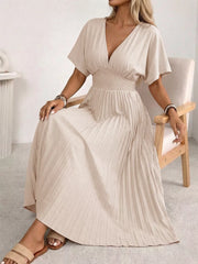 Apricot v-neck midi dress with smocked waist and pleated skirt.
