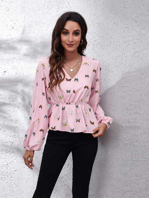 Blush pink peplum blouse with allover butterfly print, cinched waist, and balloon sleeves.