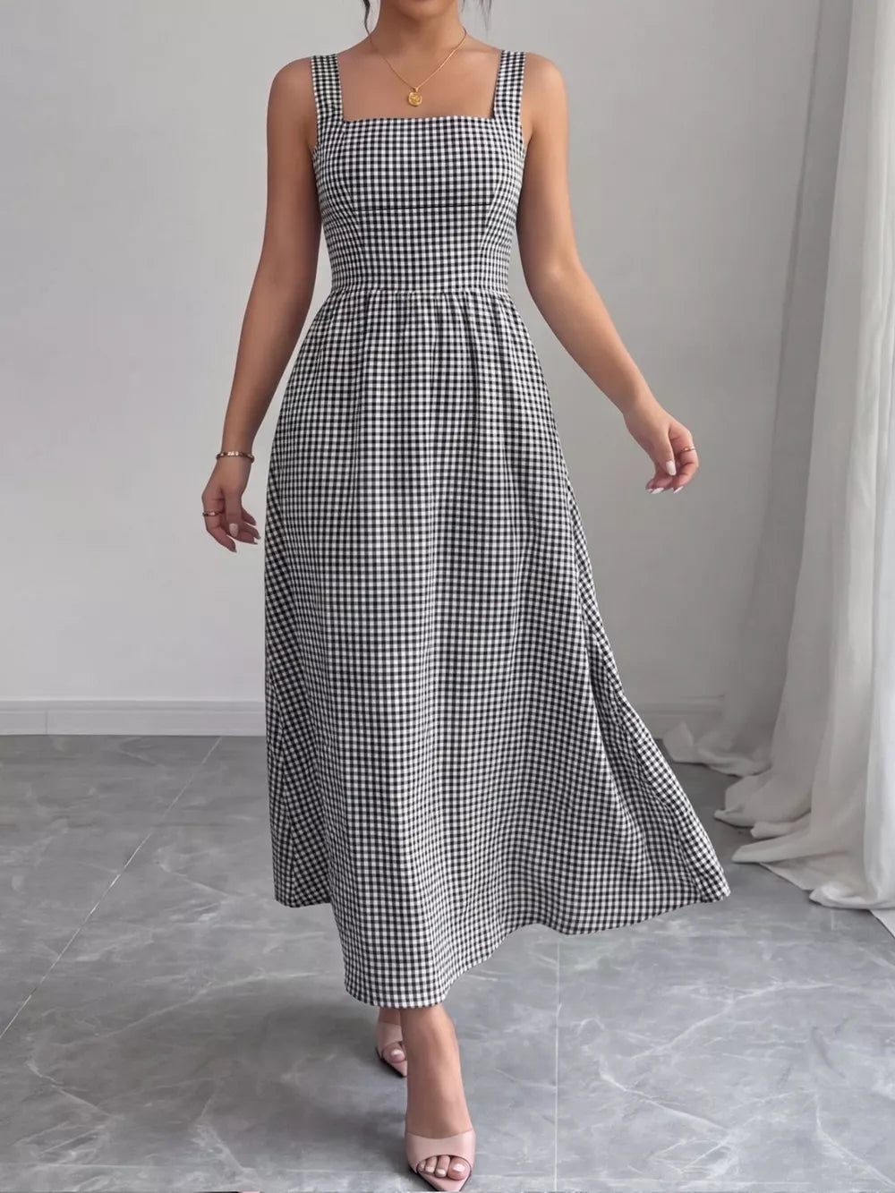 Black and white gingham midi dress with square neckline and a-line skirt.