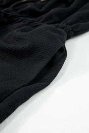 Black waffle knit wide leg jumpsuit with drawstring waist detail