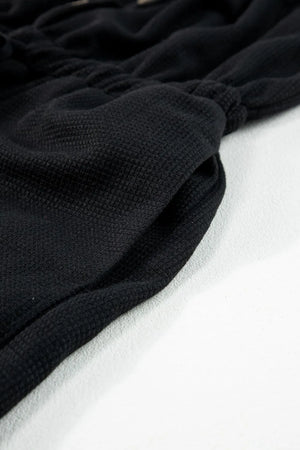 Black waffle knit wide leg jumpsuit with drawstring waist detail
