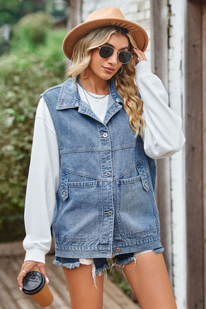 Denim vest with button front and chest pockets, layered over a white hoodie.