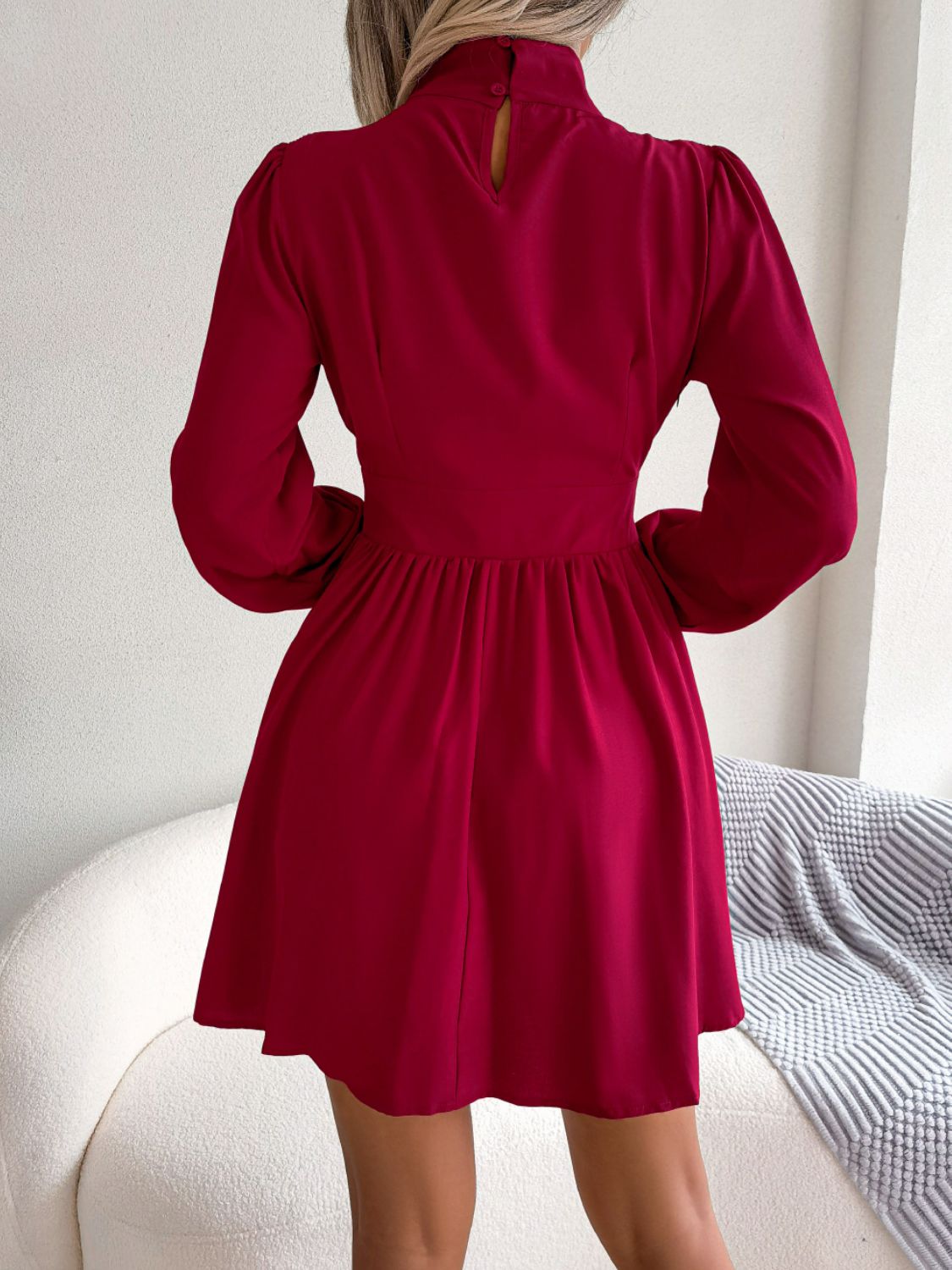 Red fit-and-flare mini dress with keyhole neckline, puff sleeves, and button detail.
