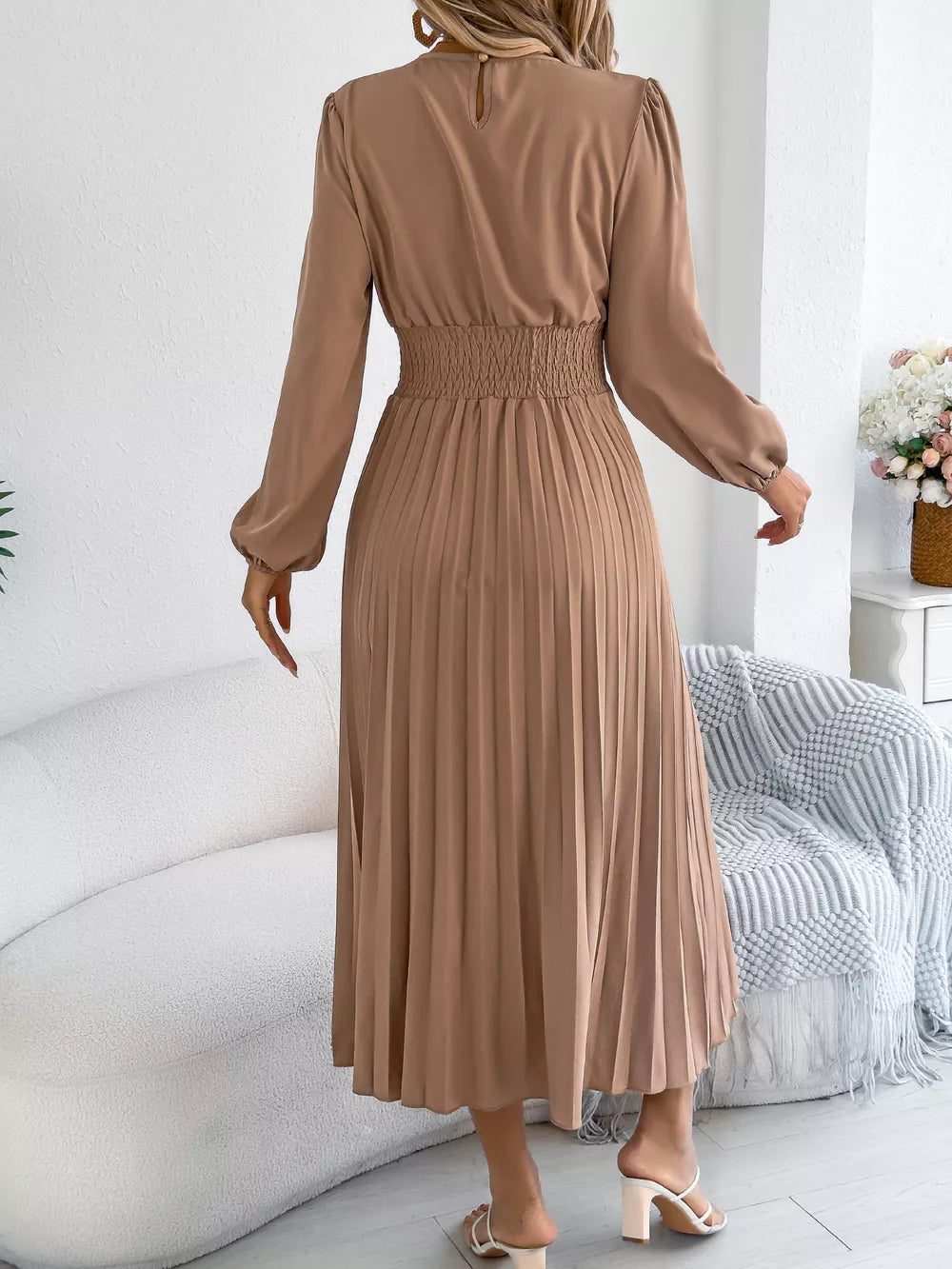 Khaki ruffled smocked waist midi dress with long sleeves and pleated skirt.