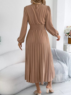 Khaki ruffled smocked waist midi dress with long sleeves and pleated skirt.