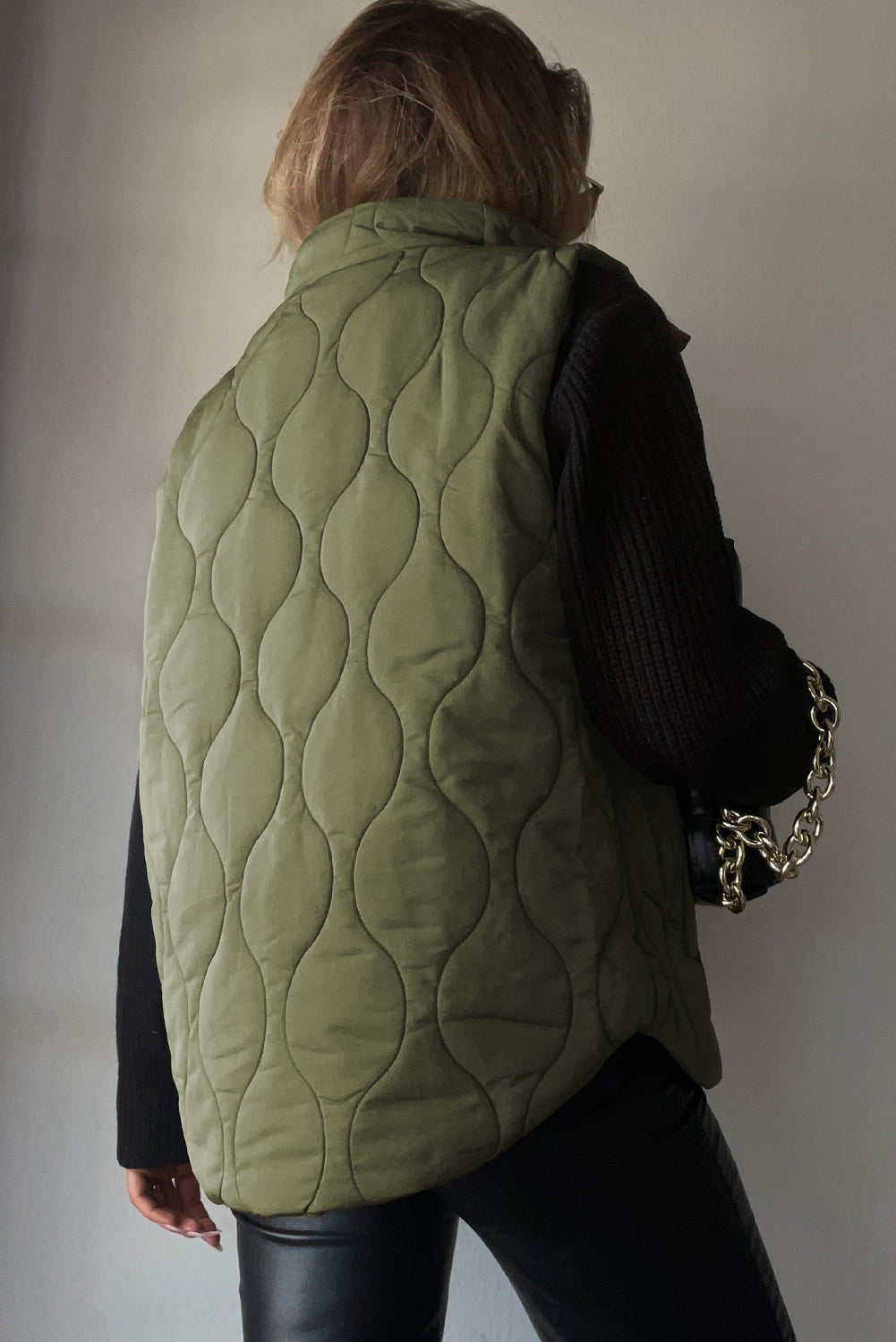 Quilted stand-collar gilet in Matcha Green with a wave pattern.